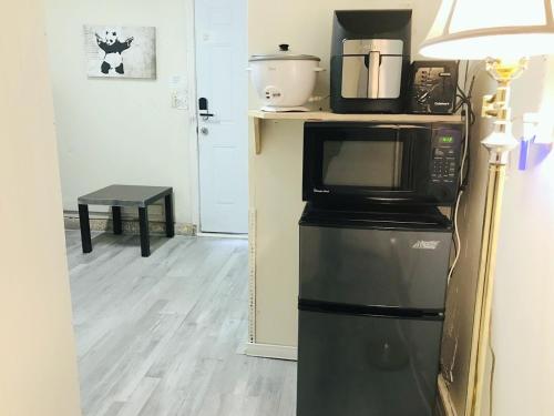 a microwave sitting on top of a refrigerator at Independent bedroom with private bathroom#2 in Las Vegas