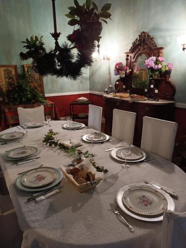 a table with plates and silverware on a table at Estancia La Rica in La Rica
