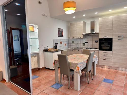 a kitchen with a table and chairs in it at Brendon Suite in Brindisi
