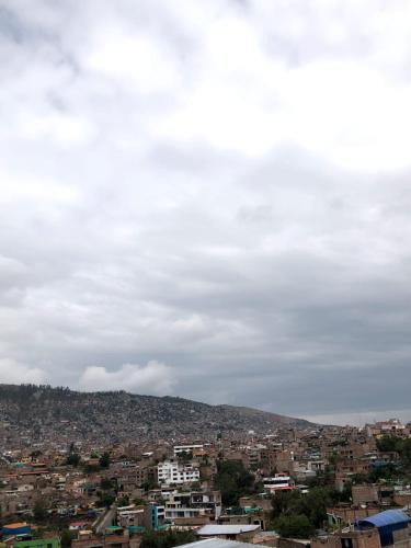 a view of a city under a cloudy sky at Hotel Los Chankas in Ayacucho