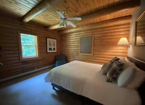 a bedroom with a bed and a ceiling fan at Rustic U.P. Retreat in Marquette in Marquette