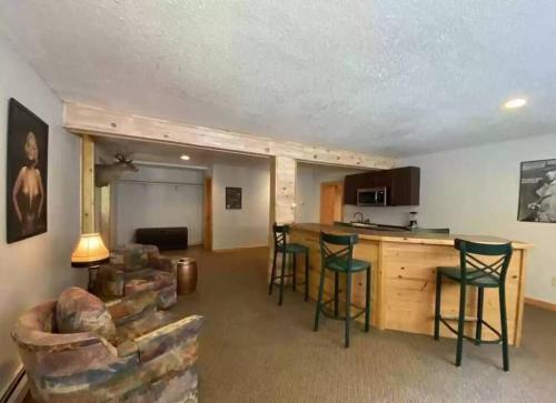 a living room with a kitchen and a table and chairs at Rustic U.P. Retreat in Marquette in Marquette