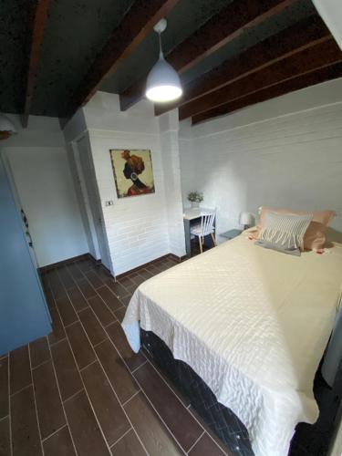 a bedroom with a white bed and a table at Casa Guemes in Santiago