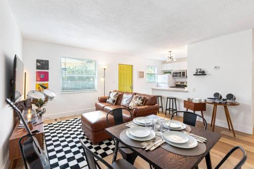 a living room with a table and a couch at Musicians Lounge - 2 BR with parking asssigned in Fort Lauderdale