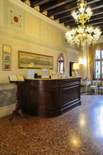 a large room with a desk and a chandelier at Ca' Amadi in Venice