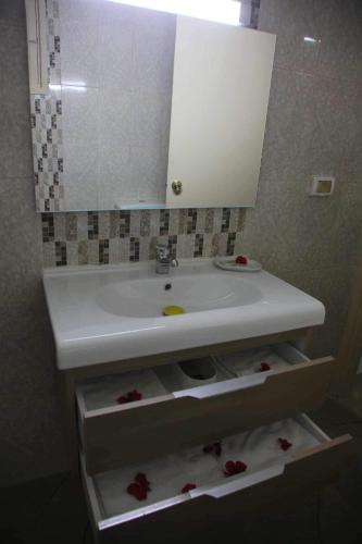 a bathroom with a white sink and a mirror at Hotel Amine in Sfax
