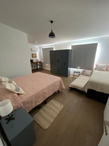 a bedroom with two beds and a tv in it at Casa Guemes in Santiago