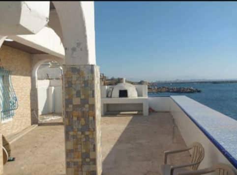 a balcony of a house with a view of the water at Villa Marame in Bordj el Bahri