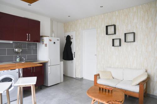 a living room with a white couch and a kitchen at Pleasant love cocoon of 30 m in Clichy in Clichy