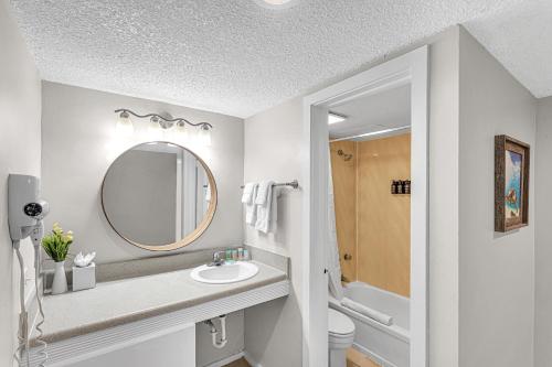a bathroom with a sink and a mirror at Sands Harbor Resort and Marina in Pompano Beach