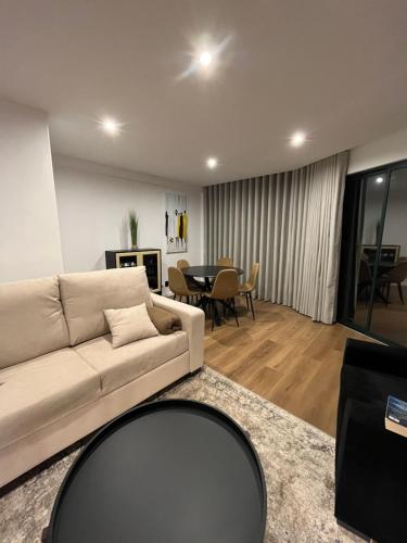 a living room with a couch and a table at Luxury View Apartment Funchal CENTRAL free parking FAMILIES in Funchal