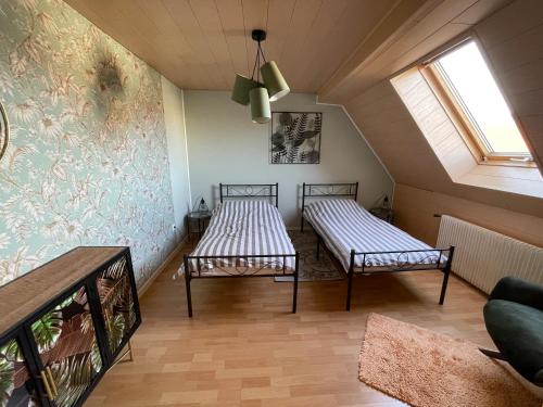 two beds in the attic of a house at Charmante Doppelhaushälfte in Tuttlingen