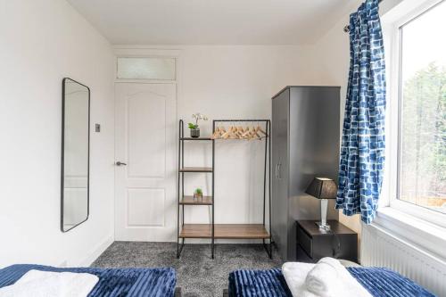 a bedroom with a bed and a shelf and a window at Modern House, Sleeps 5 in Central Coventry in Coventry