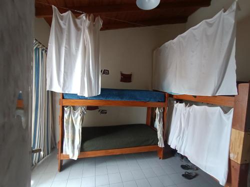 a couple of bunk beds in a room at Ruca Kiñe Hostel in Las Grutas