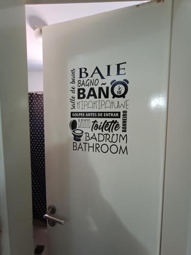 a bathroom door with the words bale atomic banking on it at Ruca Kiñe Hostel in Las Grutas