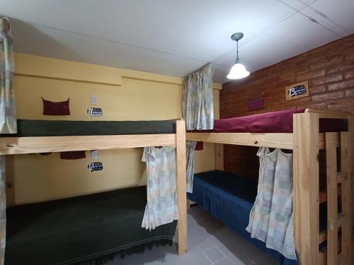 a couple of bunk beds in a room at Ruca Kiñe Hostel in Las Grutas