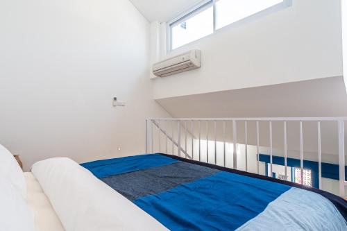 Habitación blanca con cama y ventana en The Blue Loft Canggu - free scooter use en Canggu