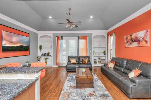 a living room with a couch and a table at Prolific 3Story w Game Room-HotTub-Near DT in Houston
