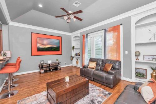 a living room with a couch and a table at Prolific 3Story w Game Room-HotTub-Near DT in Houston