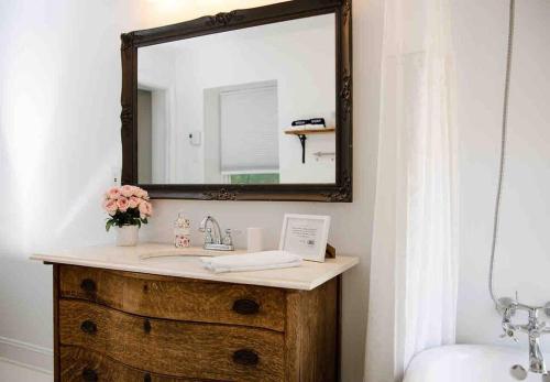 a bathroom with a sink and a mirror at Colonial Chic - 3BR home, VA wine country near Harpers Ferry in Purcellville