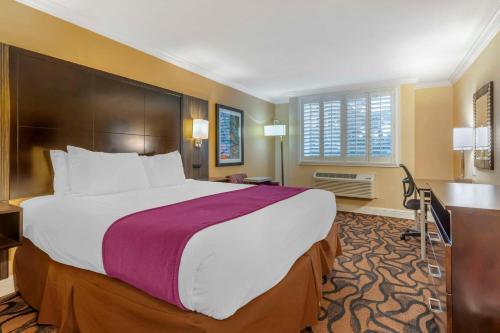 a hotel room with a large bed and a window at Best Western Plus Airport Plaza in San Jose