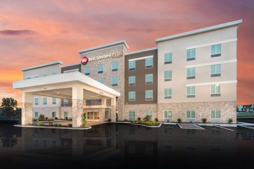 a rendering of a hotel with a sunset in the background at Best Western Plus St. Louis Airport Hotel in Saint Louis