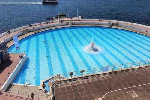 a large swimming pool on a cruise ship at Grand Apartment on HOE/BARBICAN Allocated PARKING! in Plymouth