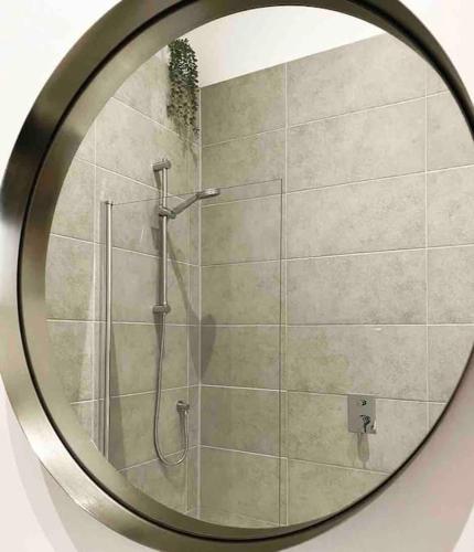 a mirror with a shower in a bathroom at Grand Apartment on HOE/BARBICAN Allocated PARKING! in Plymouth