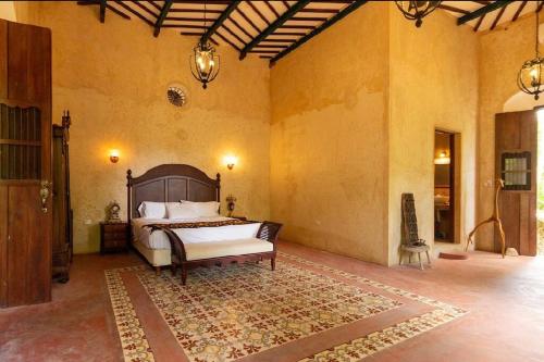 a bedroom with a bed and a rug at Spectacular Hacienda Henequenera with Cenote 