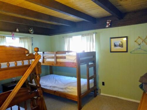 a bedroom with two bunk beds and a window at The Last Run - 4BR Chalet between Mt. Snow & Stratton in Wardsboro