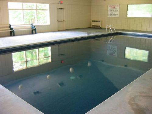 a large swimming pool in a building at The Last Run - 4BR Chalet between Mt. Snow & Stratton in Wardsboro