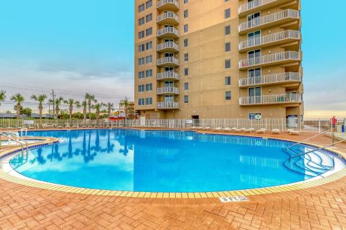 a large swimming pool in front of a building at Tidewater Beach Resort in Panama City Beach