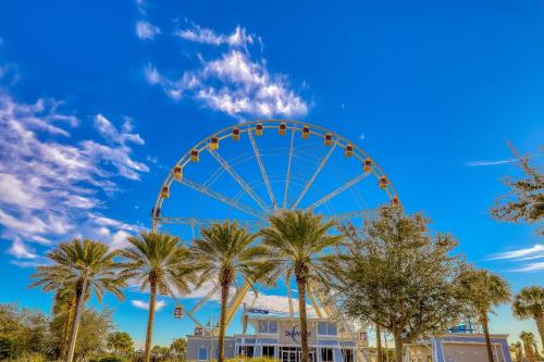 a ferris wheel in a park with palm trees at Tidewater Beach Resort in Panama City Beach