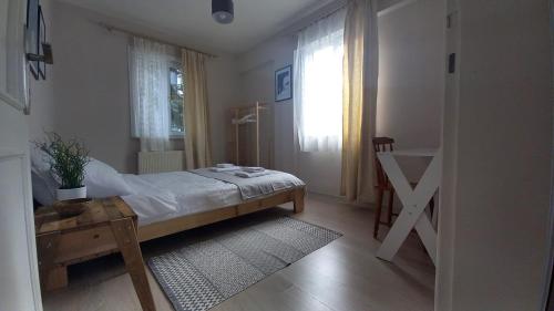 a bedroom with a bed and a table and a window at Tartaruga Boutique Hotel & Bungalows in Şile