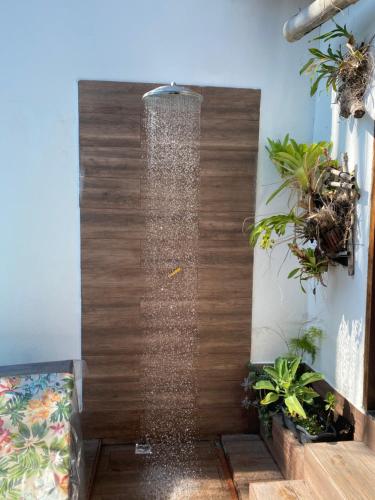 a water fountain in a room with plants at Casa Paraty Mara in Paraty