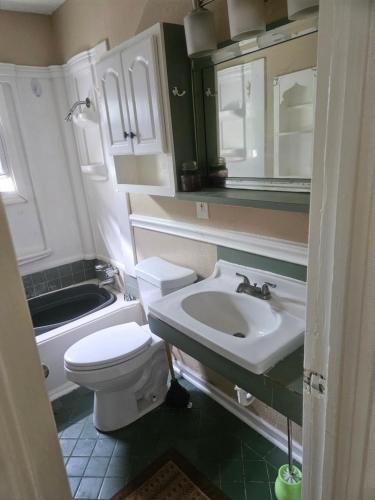 a small bathroom with a toilet and a sink at RestStop Hostel in Houston