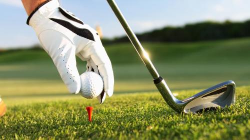 a person holding a golf ball and a club at InterContinental Tashkent by IHG in Tashkent