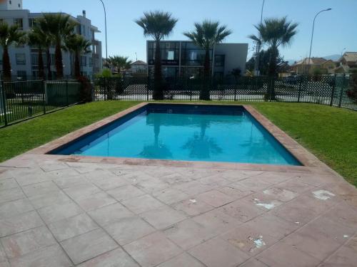 a swimming pool in the middle of a yard at Departamento en Barrio Exclusivo - La Serena in La Serena