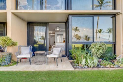 a patio with chairs and a table in front of a building at KIHEI SURFSIDE #110 condo in Wailea