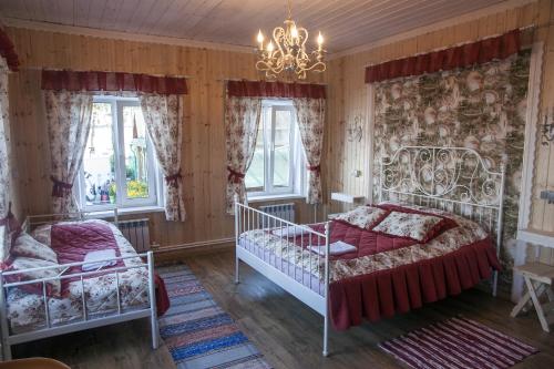 a bedroom with a bed and a chandelier at Lubas Apartment Monastery View in Kostroma