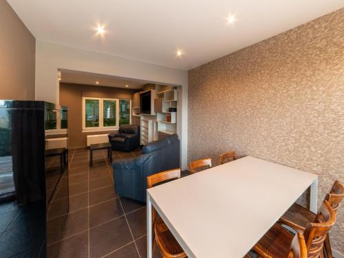 a living room with a white table and chairs at Magnificent holiday home with hot tubs in Esneux