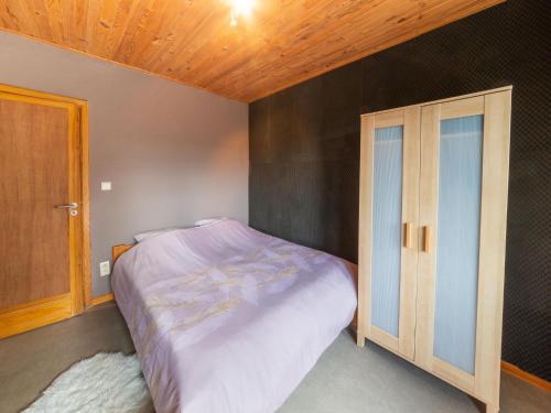 a bedroom with a bed and a wooden ceiling at Magnificent holiday home with hot tubs in Esneux