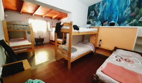 a dorm room with bunk beds and a table at Alquimia in San Marcos Sierras