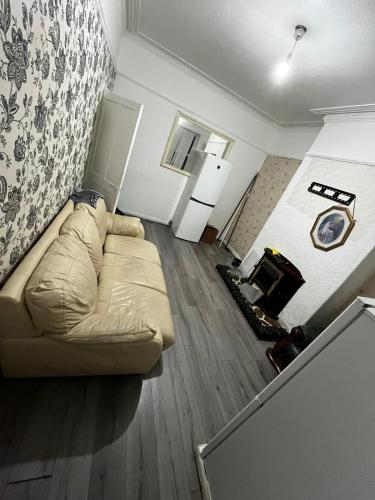 a living room with a couch and a fireplace at 28 Vicarage Street in Failsworth