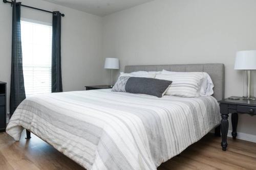 a bedroom with a large bed with a white blanket at Bayou Retreat-Located on Tranquill Bayou Lafourche in Thibodaux