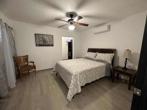 a bedroom with a bed and a ceiling fan at Treviso San Marino in Rosarito