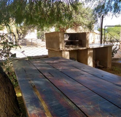 a wooden picnic table with a wooden at La casona de San José in Cachí