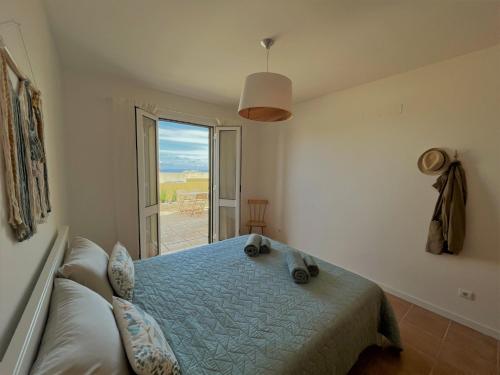 a bedroom with a bed and a window with a view at Porto Santo Happy Place in Porto Santo
