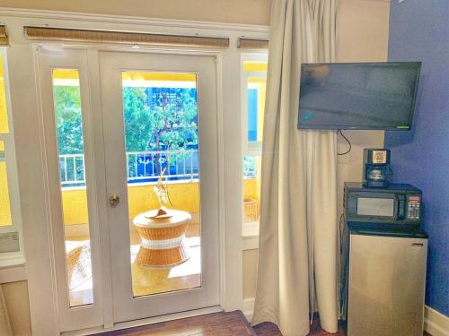 a room with a door with a tv and a window at The Chadwick in San Diego