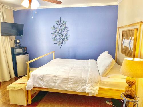 a bedroom with a bed with a blue wall at The Chadwick in San Diego